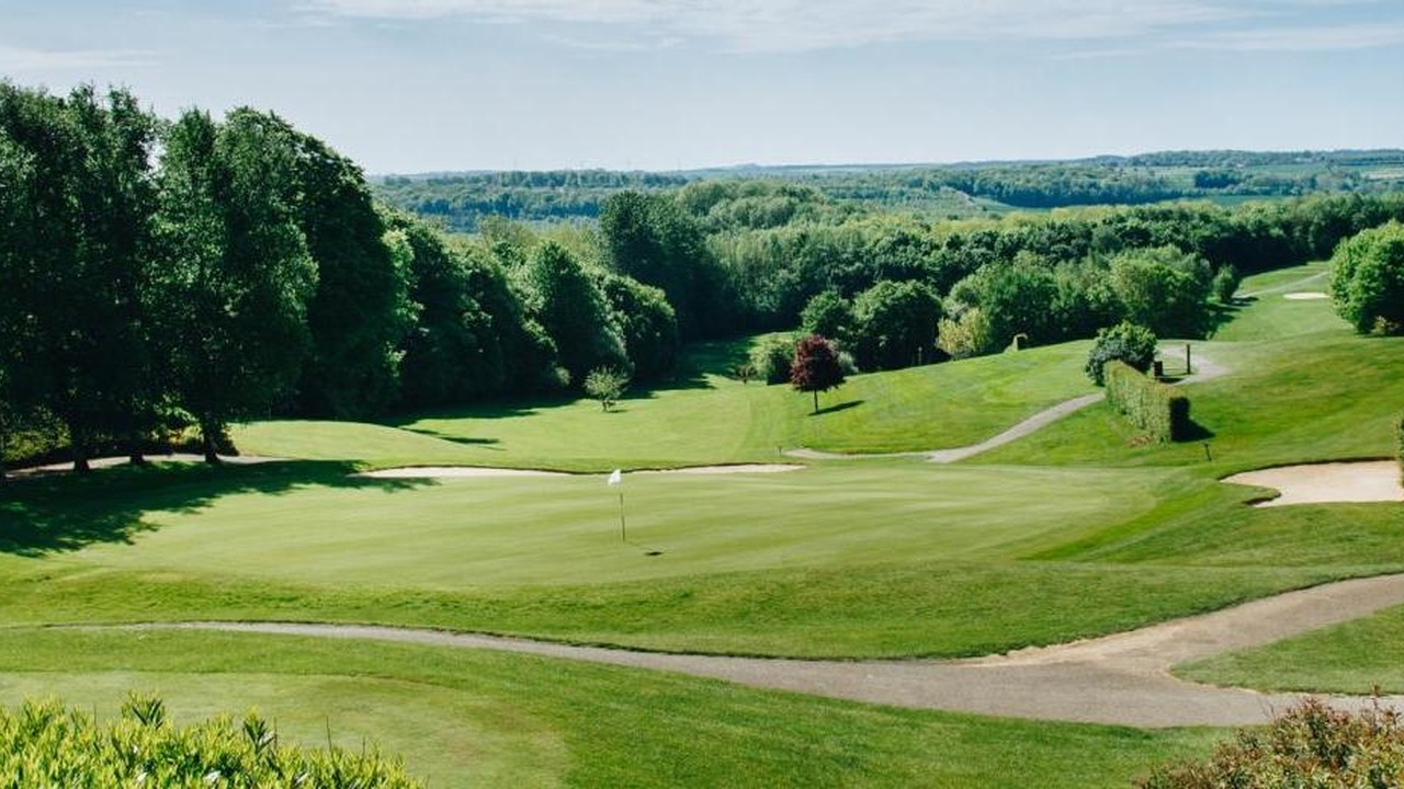 Green et fairway vallonnés bordés d’arbres au AA Saint-Omer Golf Club.